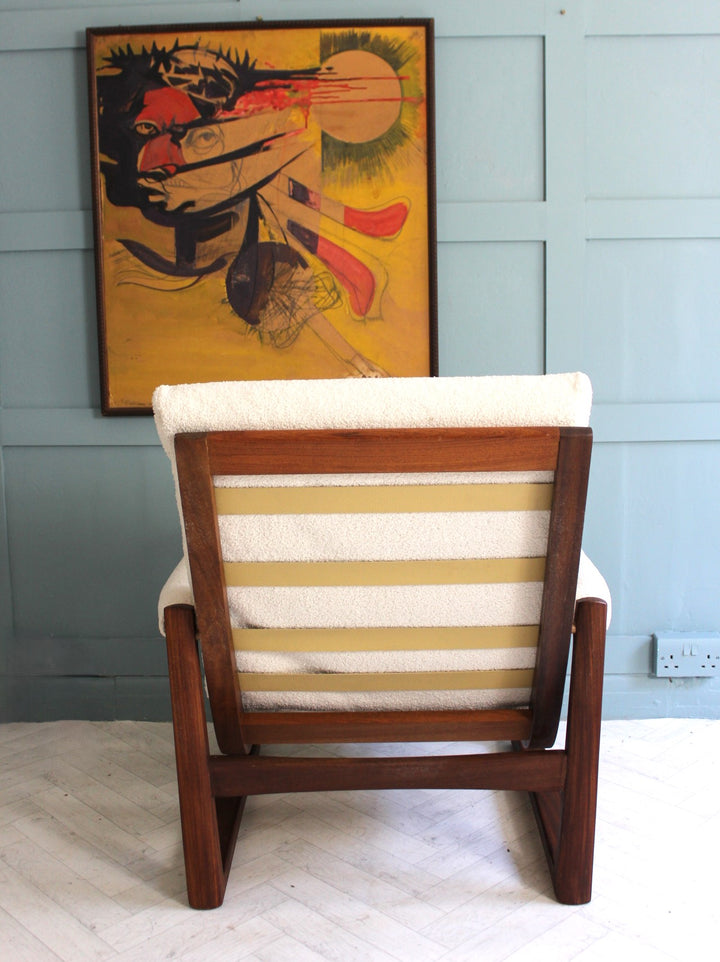 Classic midcentury armchair with solid teak frame and soft boucle seating