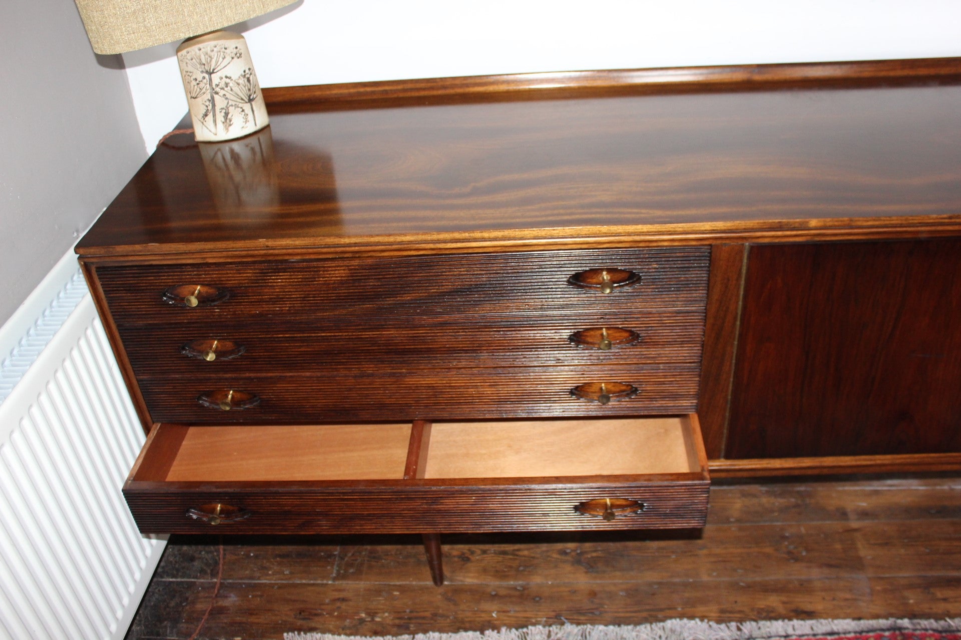 Close-up of book-matched veneered doors on a heritage-designed sideboard