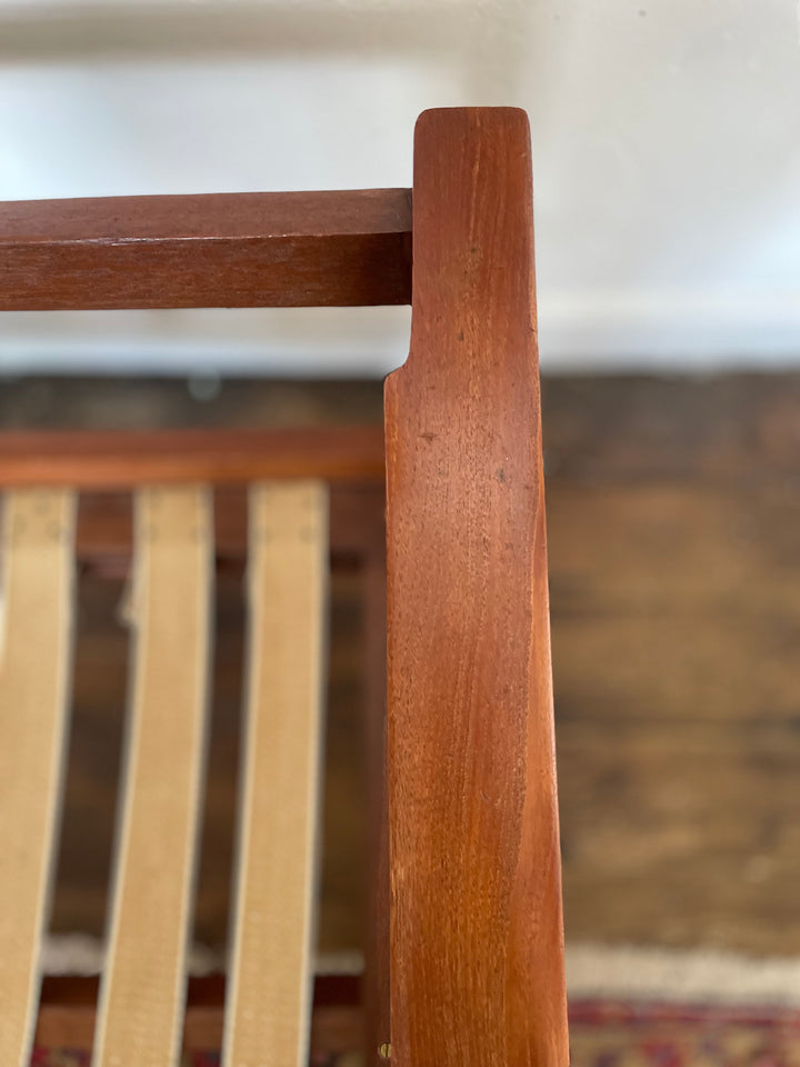 Close-up of teak frame and cushion detail on Danish mid century modern rocking chair