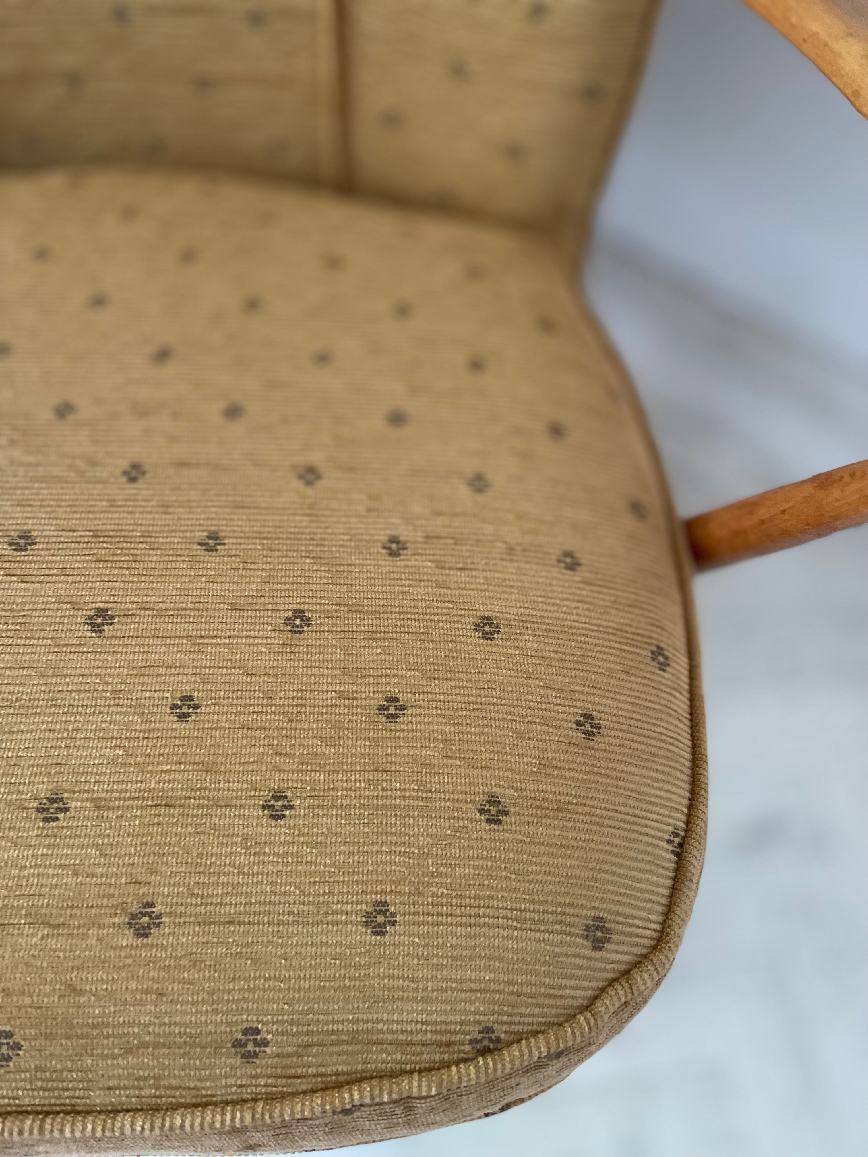 Close-up of a mustard cushion with a subtle pattern on a white background