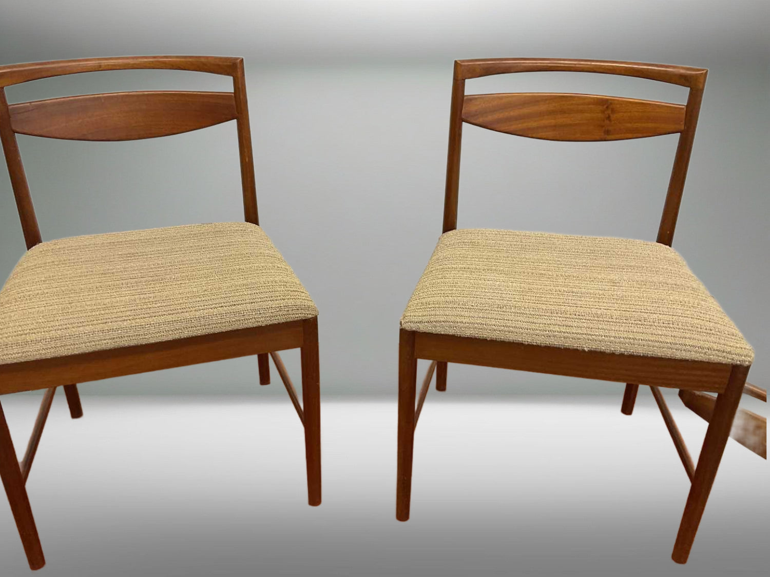 Elegant mid-century modern teak dining chair with slim legs and clean geometric forms for stylish interiors