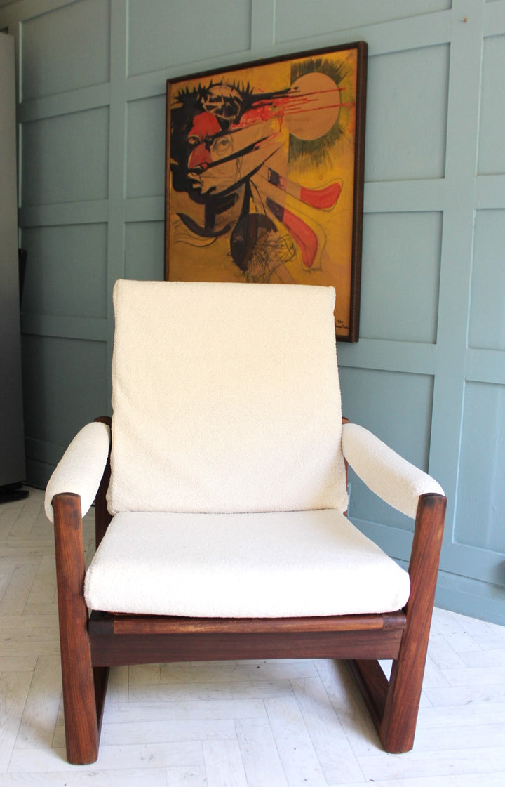 Ivory boucle upholstered lounge chair with classic midcentury aesthetic
