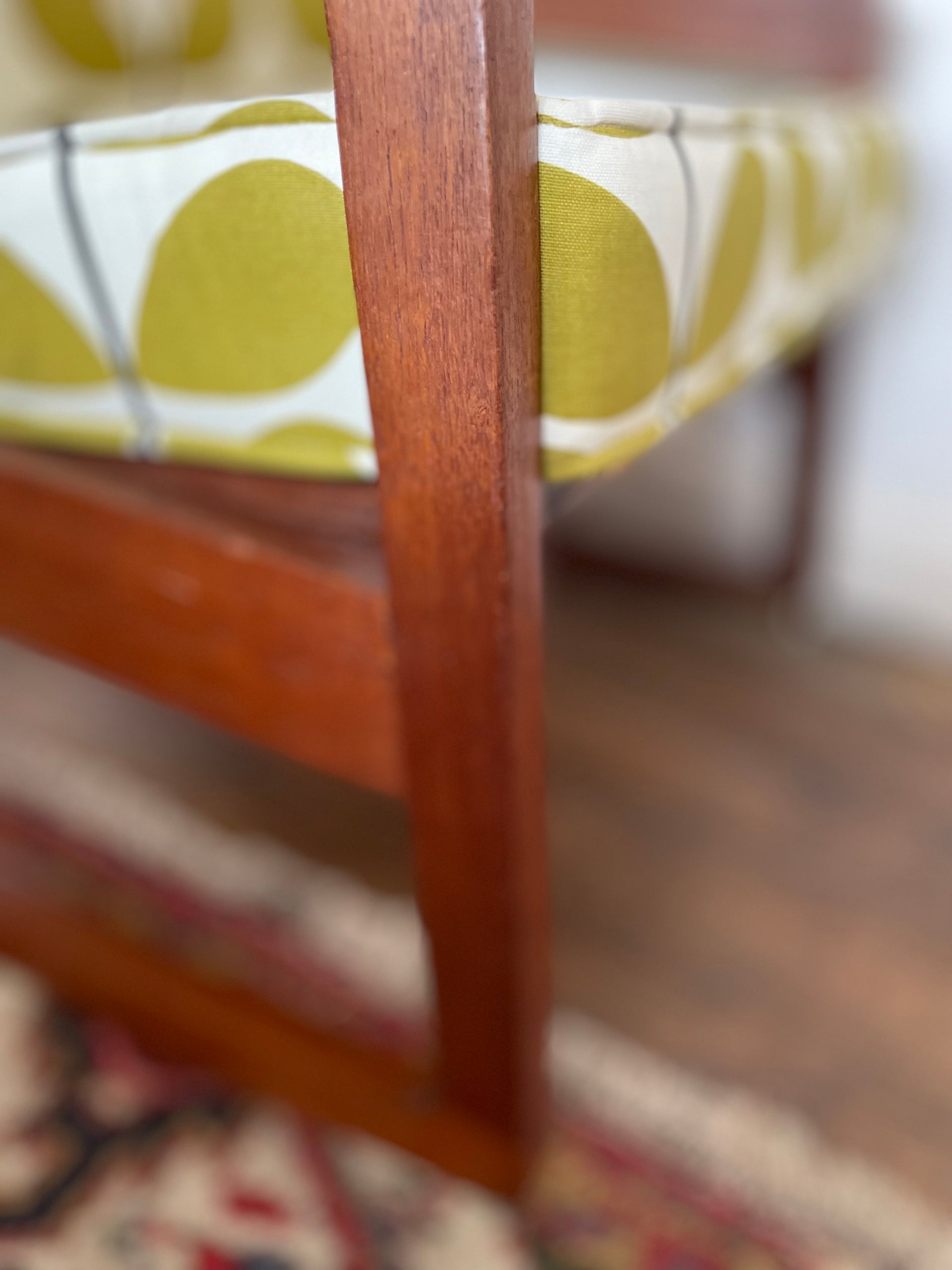 Mid-century modern teak rocking chair with bold retro fabric