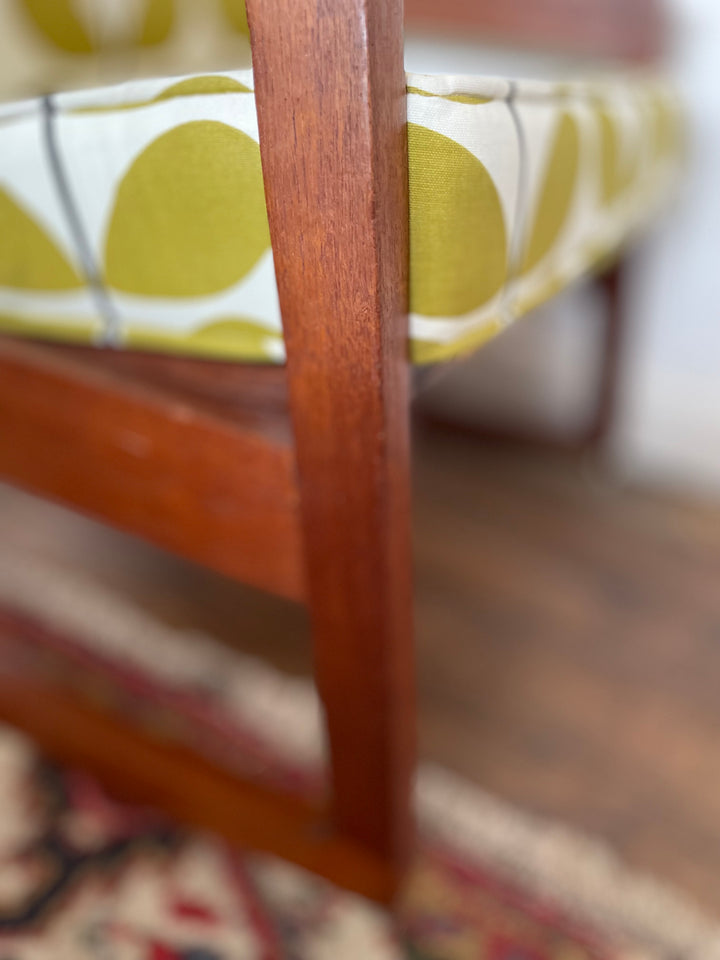 Mid-century modern teak rocking chair with bold retro fabric
