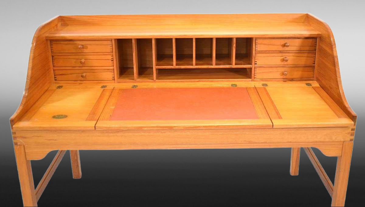 Retro wooden desk with brick-red leather writing blot