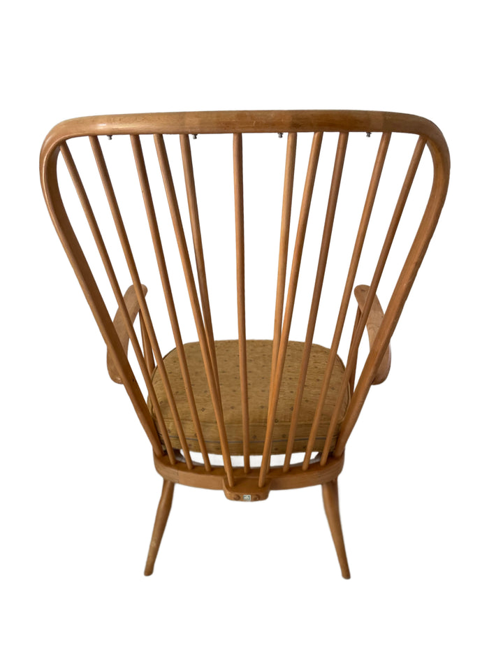 Side view of two Ercol Windsor high back grandfather armchairs, vintage mid century