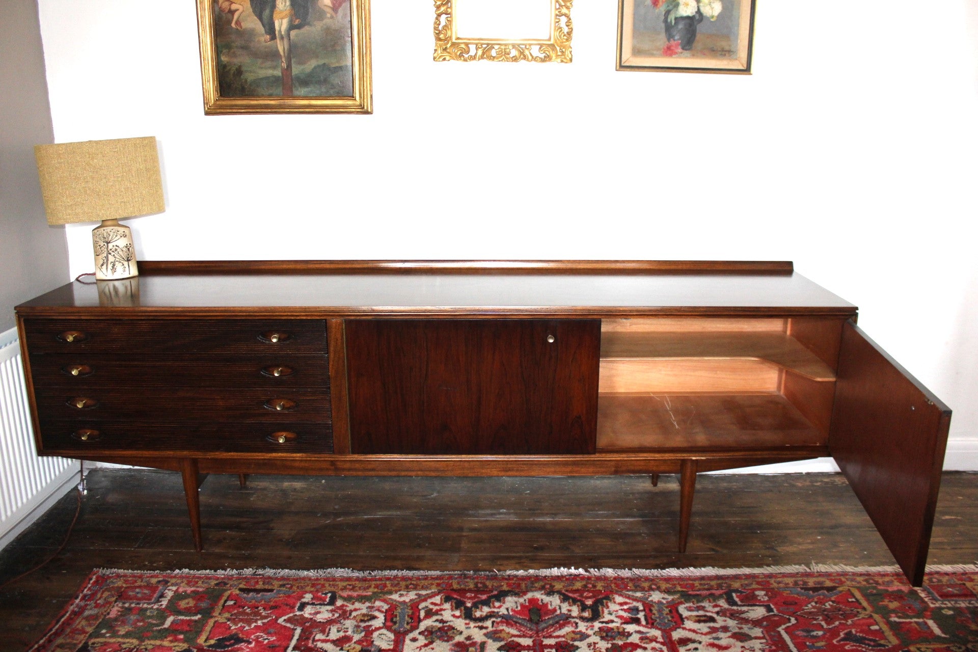 Side view of vintage mid century sideboard with narrow tapered legs