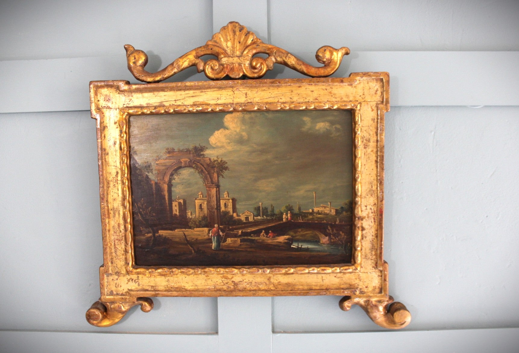 Venetian oil painting featuring an archway, figures, and rustic houses