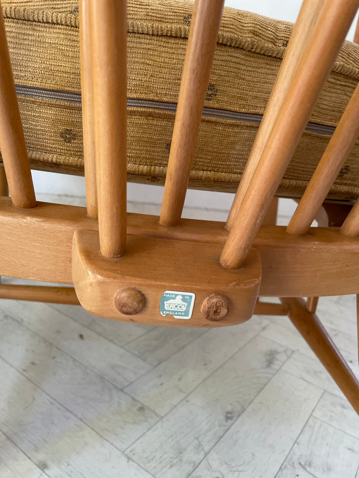 Close-up of a wooden chair with a woven seat on a light wooden floor.