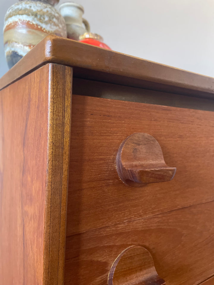 Close-up of teak grain on vintage Stag Fineline tallboy chest of drawers