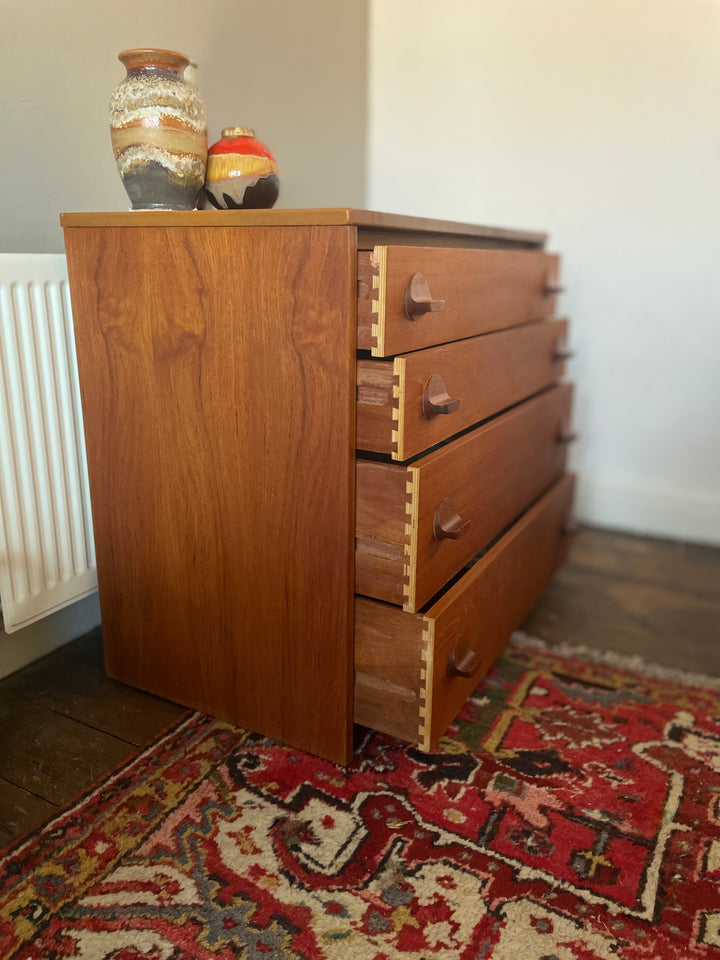 Side profile of mid century teak Stag Fineline tallboy dresser - featuring dovetail joints