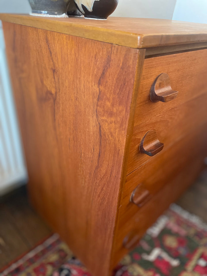 Close-up of teak grain on vintage Stag Fineline tallboy chest of drawers