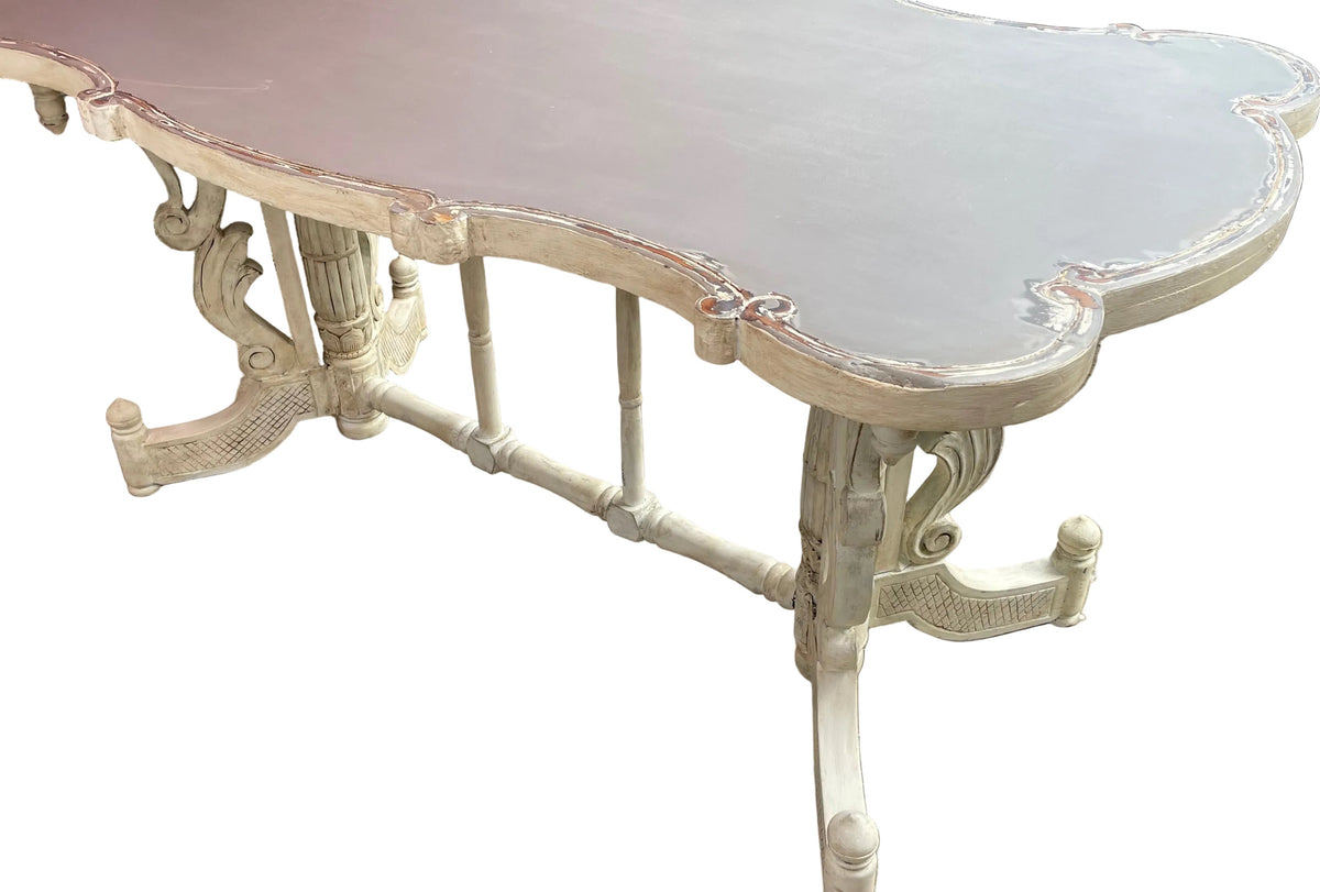  white carved wooden table with a scalloped top