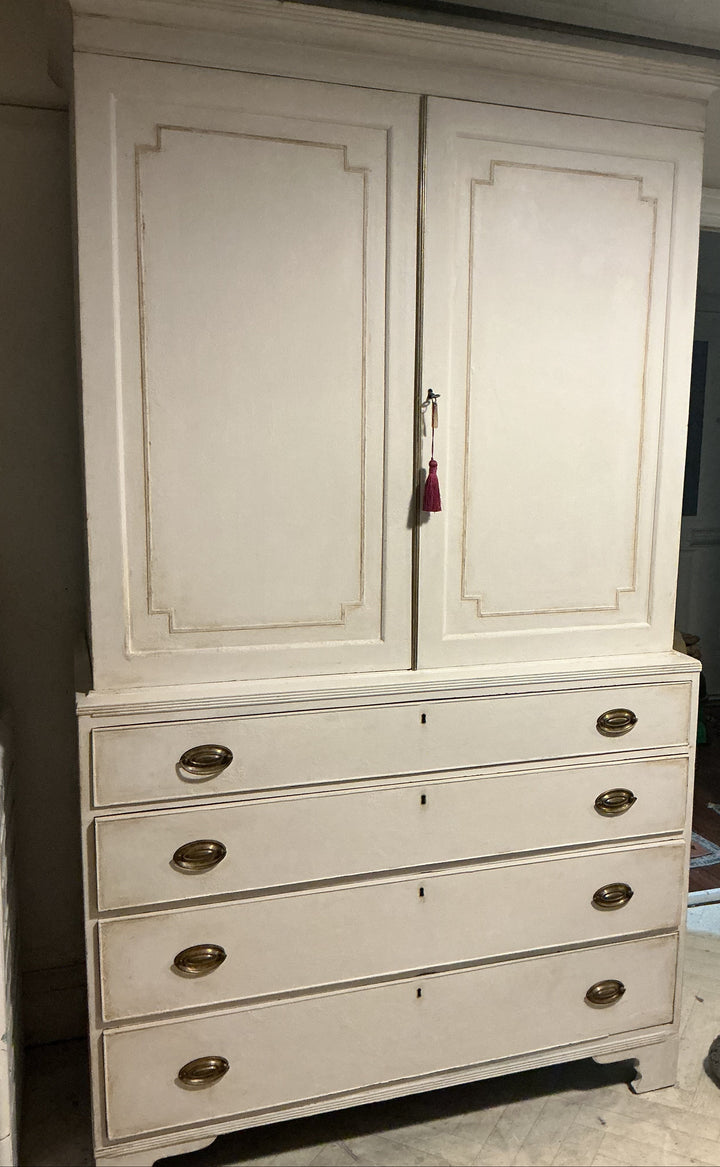 tall white painted wooden hutch or dresser with two upper cabinet doors and five drawers below, featuring distressed beige edging and brass oval handles