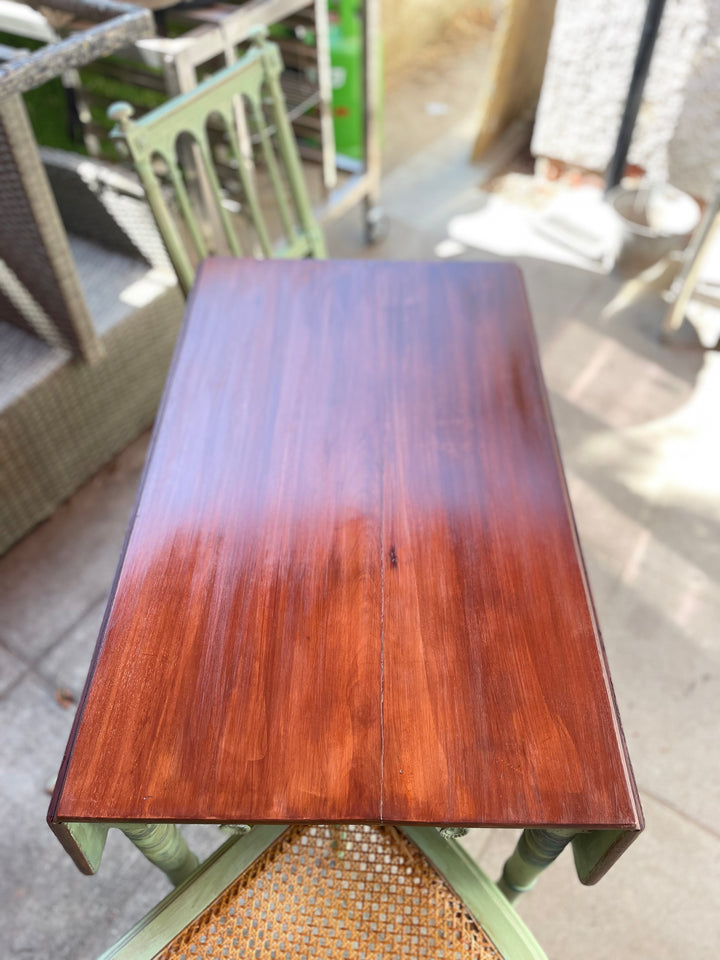 A rectangular wooden table with a glossy reddish-brown mahogany finish