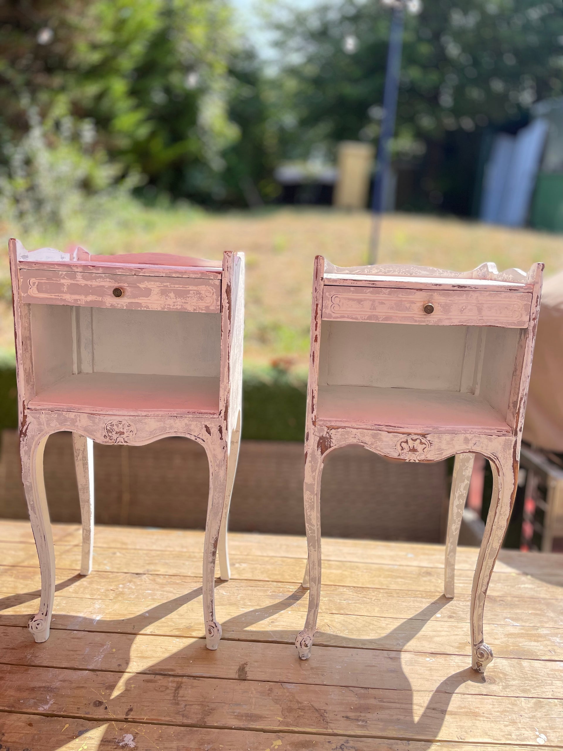 A pair of French bedside tables in white grey close up