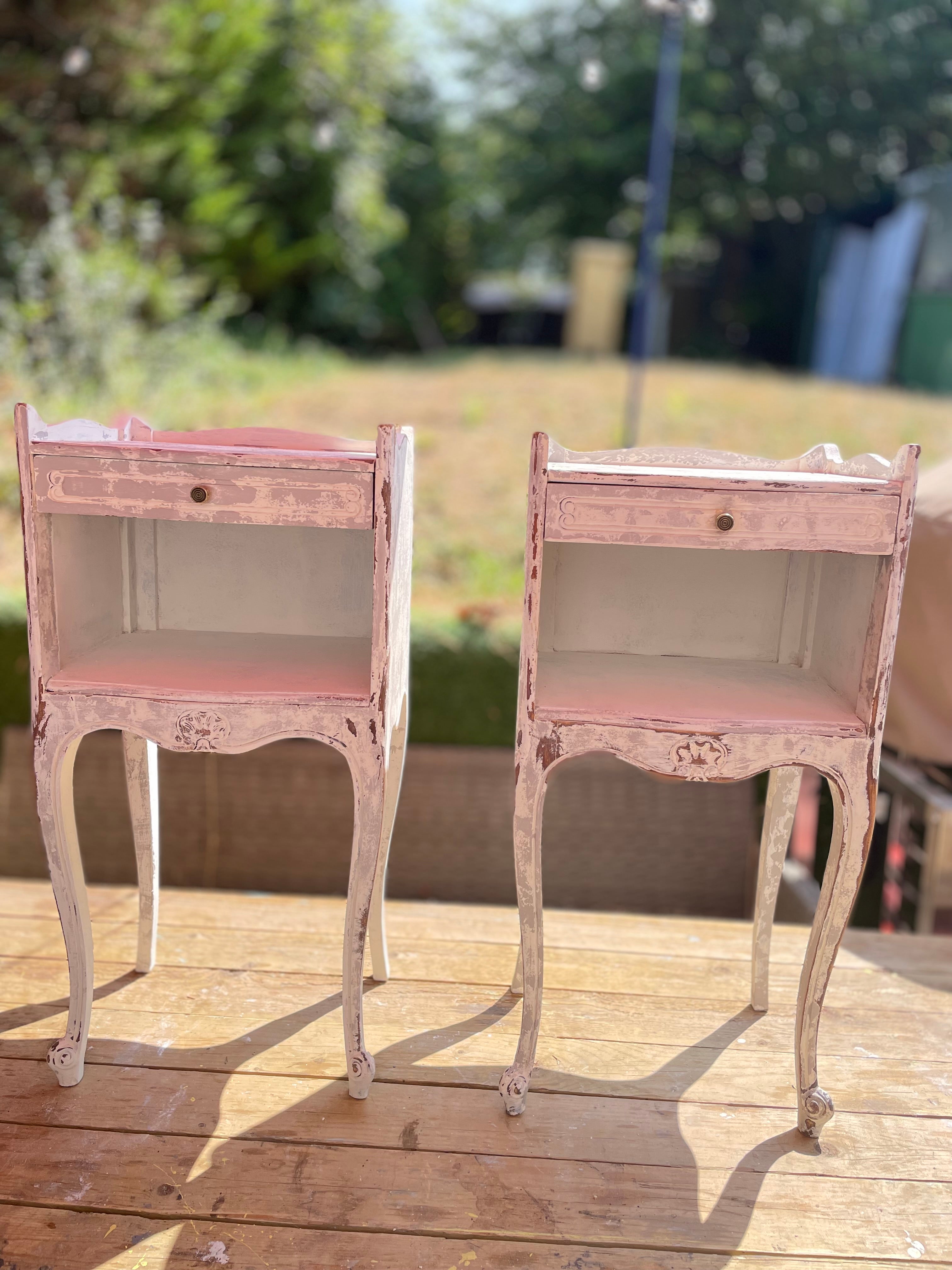 A pair of French bedside tables in white grey close up