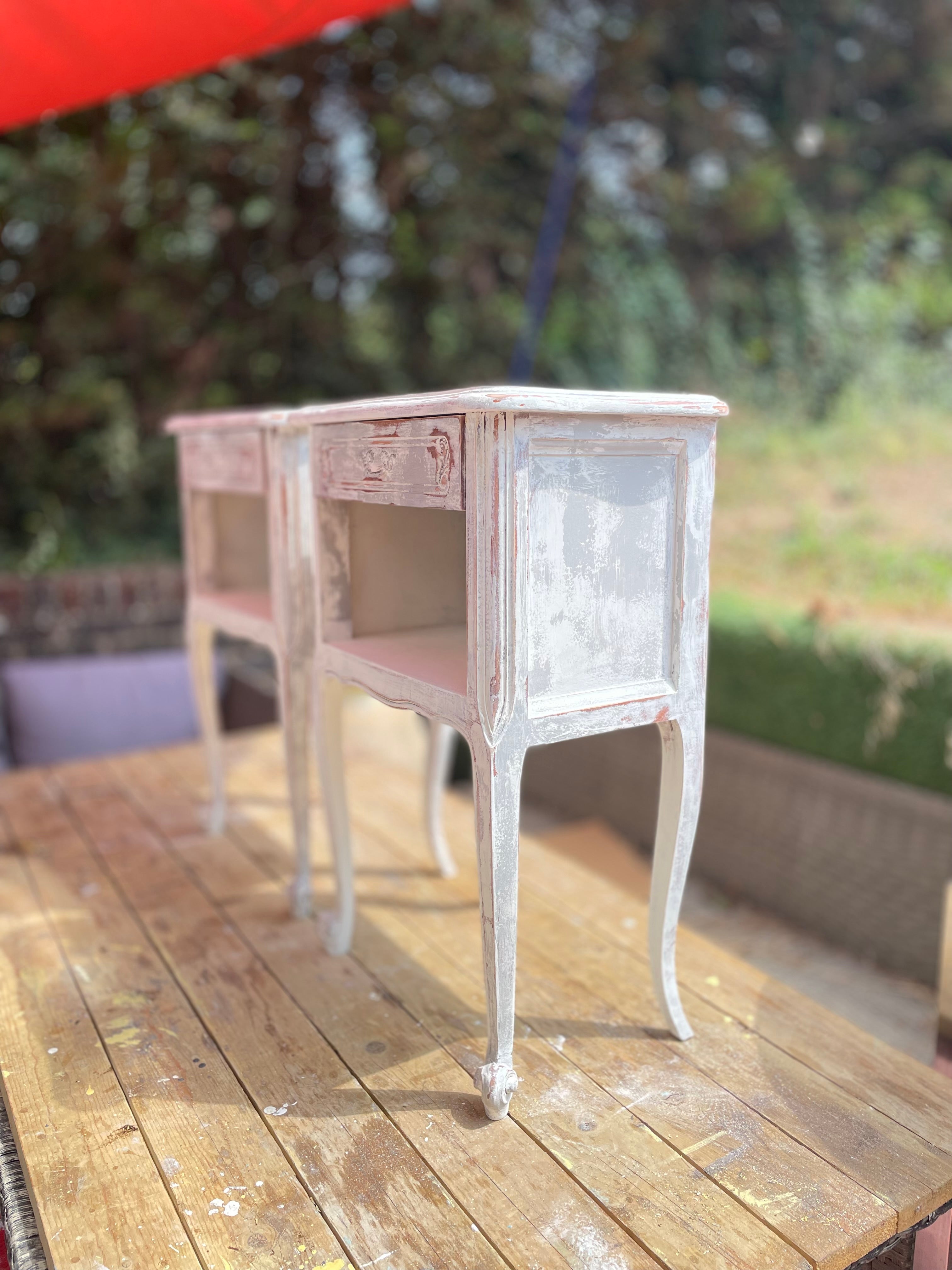 A set of two French bedside tables side view
