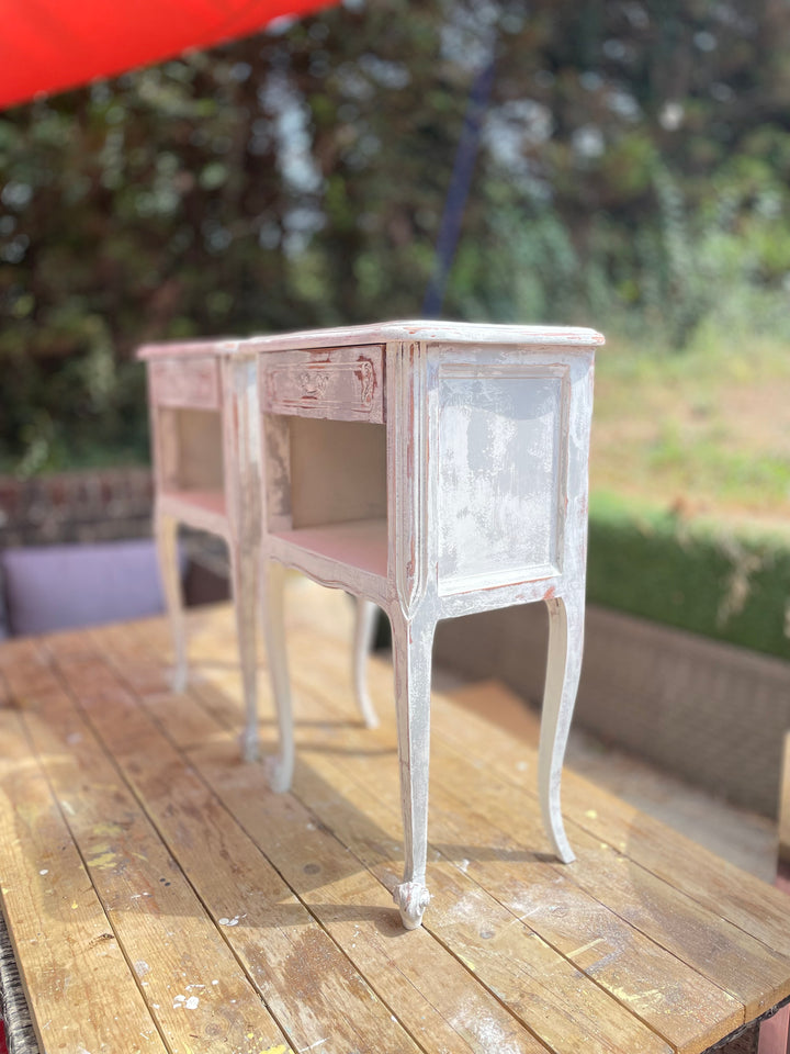 A set of two French bedside tables side view