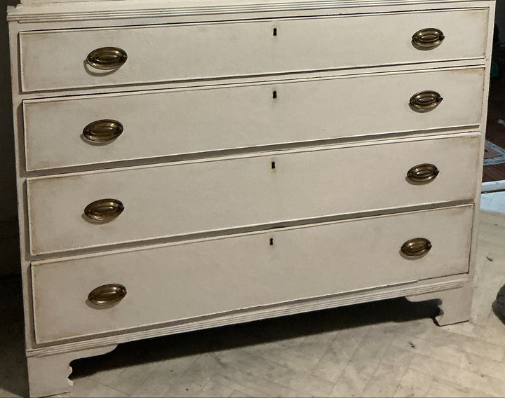a matching upper cabinet door section, featuring brass-style oval handles and a small tassel hanging from the center door.