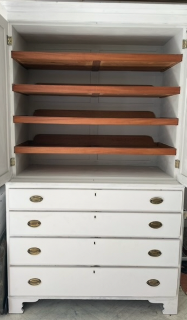 white wooden cabinet with five drawers and brass handles, featuring an open upper door with four wooden shelves inside, shown against a neutral indoor background.