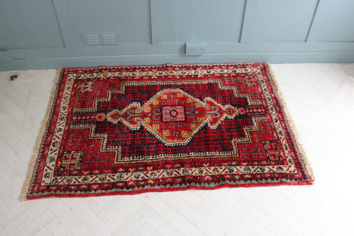 Authentic vintage Persian area rug with medium-length white fringe, perfect for a living room or dining room.