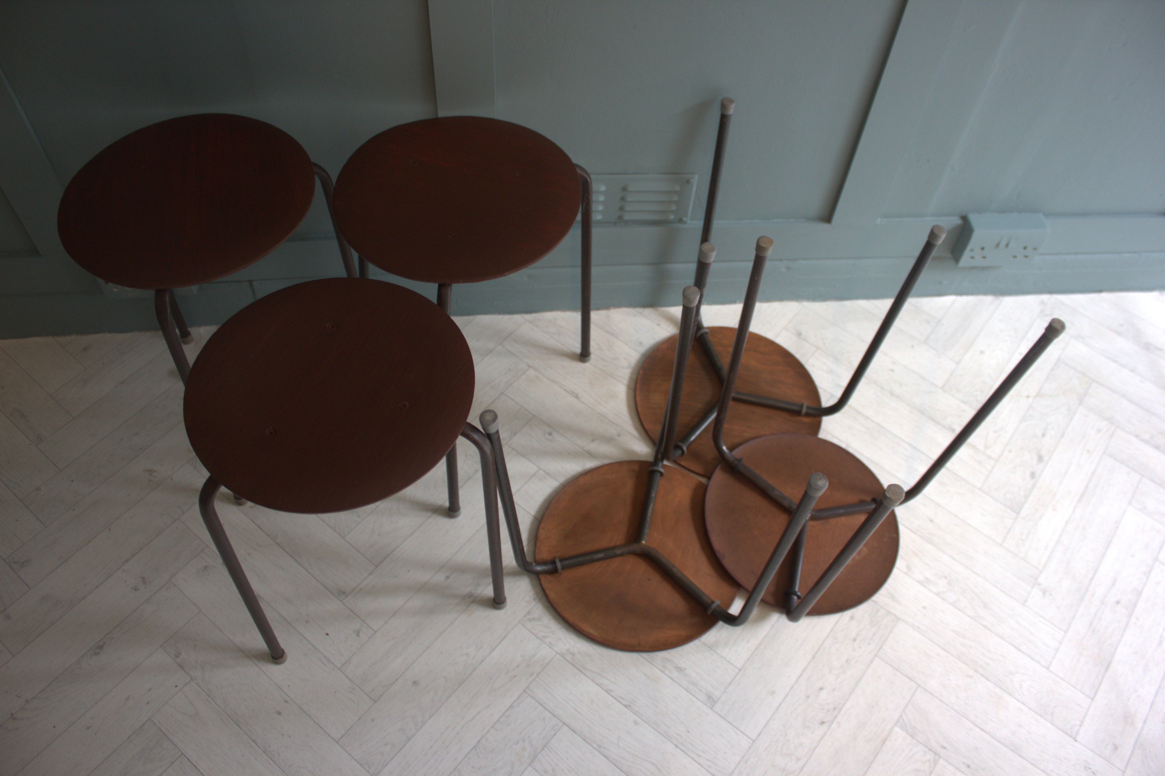 Close-up of vintage Arne Jacobsen teak stool with tripod legs