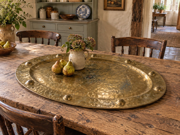 Decorative_brass_tray_displayed_on_a_rustic_farmhouse_table