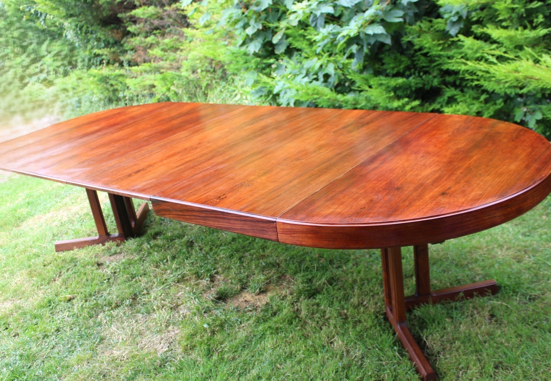 Elegant rosewood dining table with smooth craftsmanship and a polished finish.