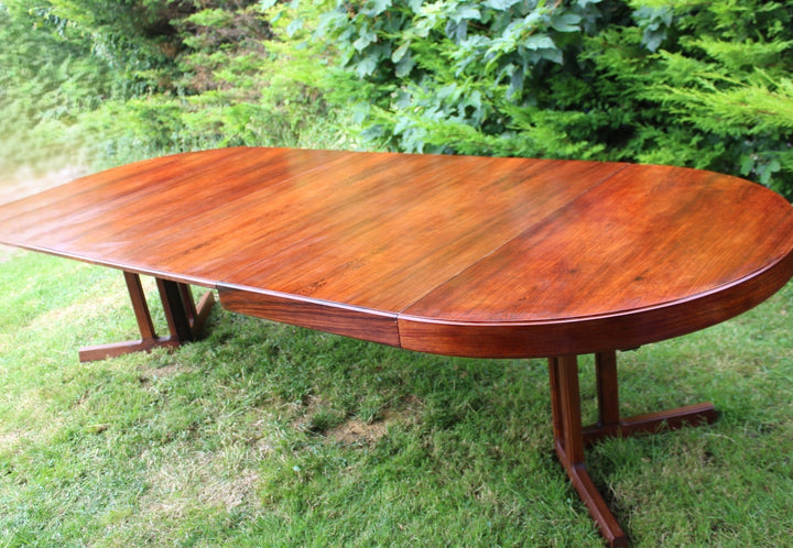 Elegant rosewood dining table with smooth craftsmanship and a polished finish.