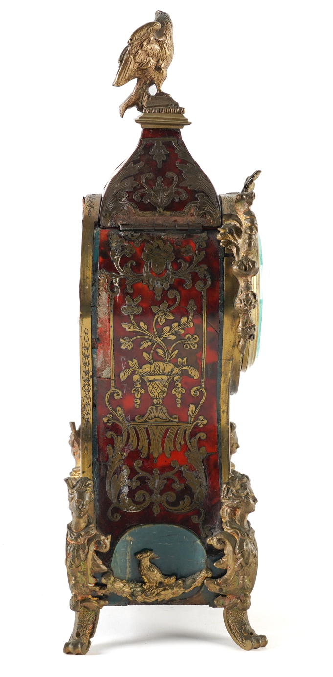 An ornate vintage-style decorative cabinet or display box with a gold-toned frame, intricate red and gold patterned front panel, a bird figurine on top, and a small blue cushion or panel near the base, shown on a white background within a phone app screenshot.