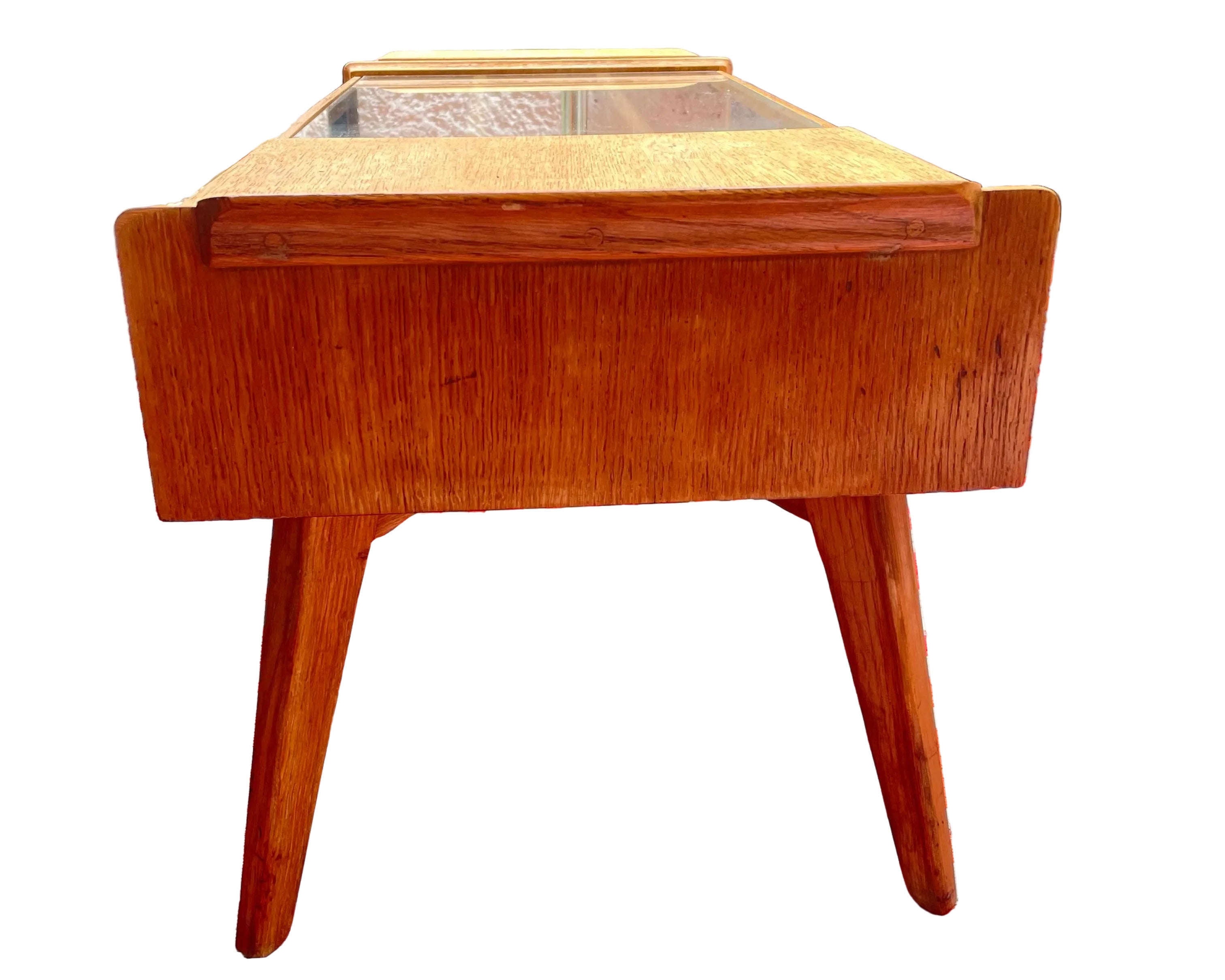 Wooden side table on a red and white patterned rug outdoors g plan