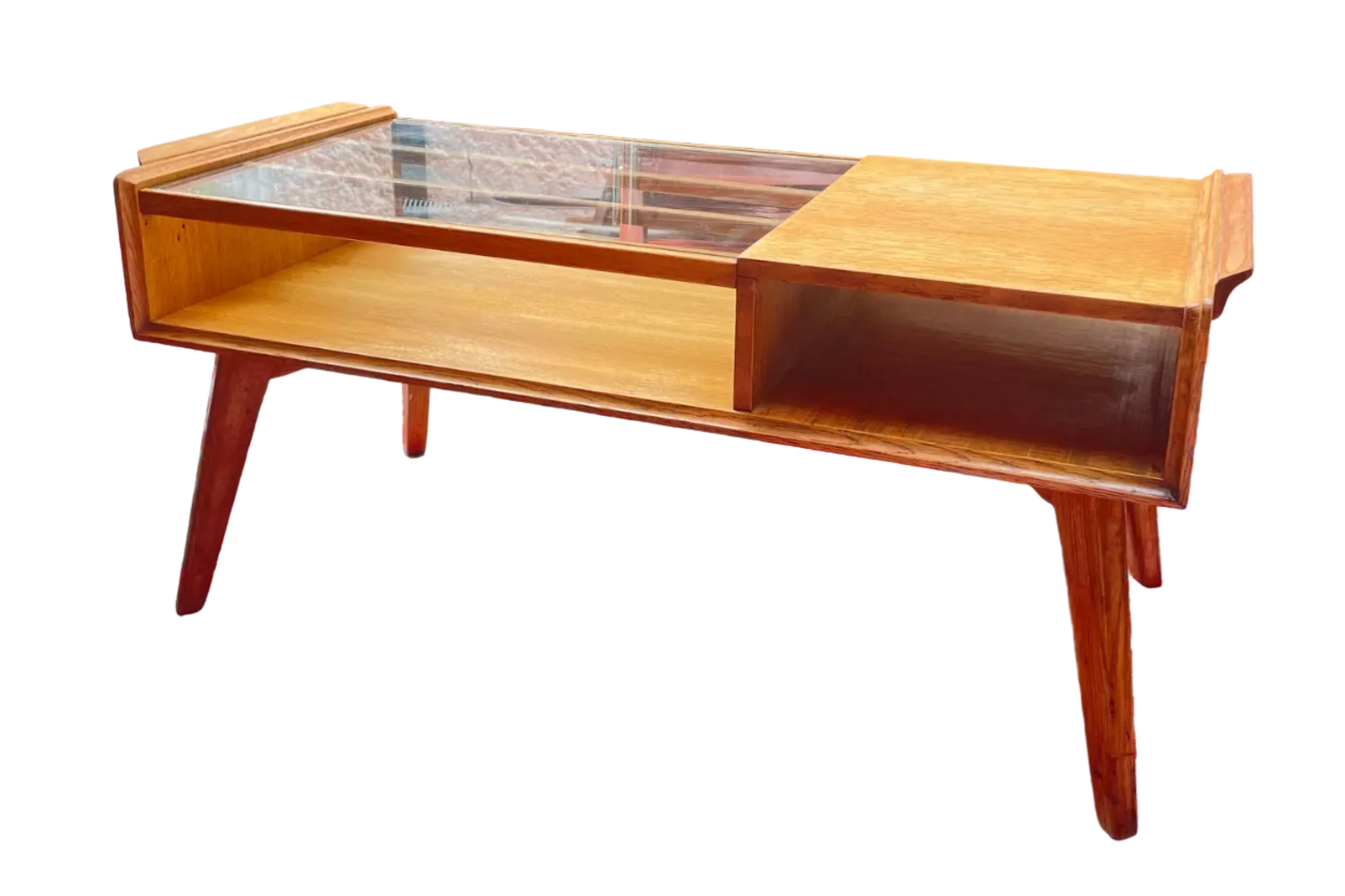Wooden g plan coffee table on a red and white patterned rug with a garden in the background