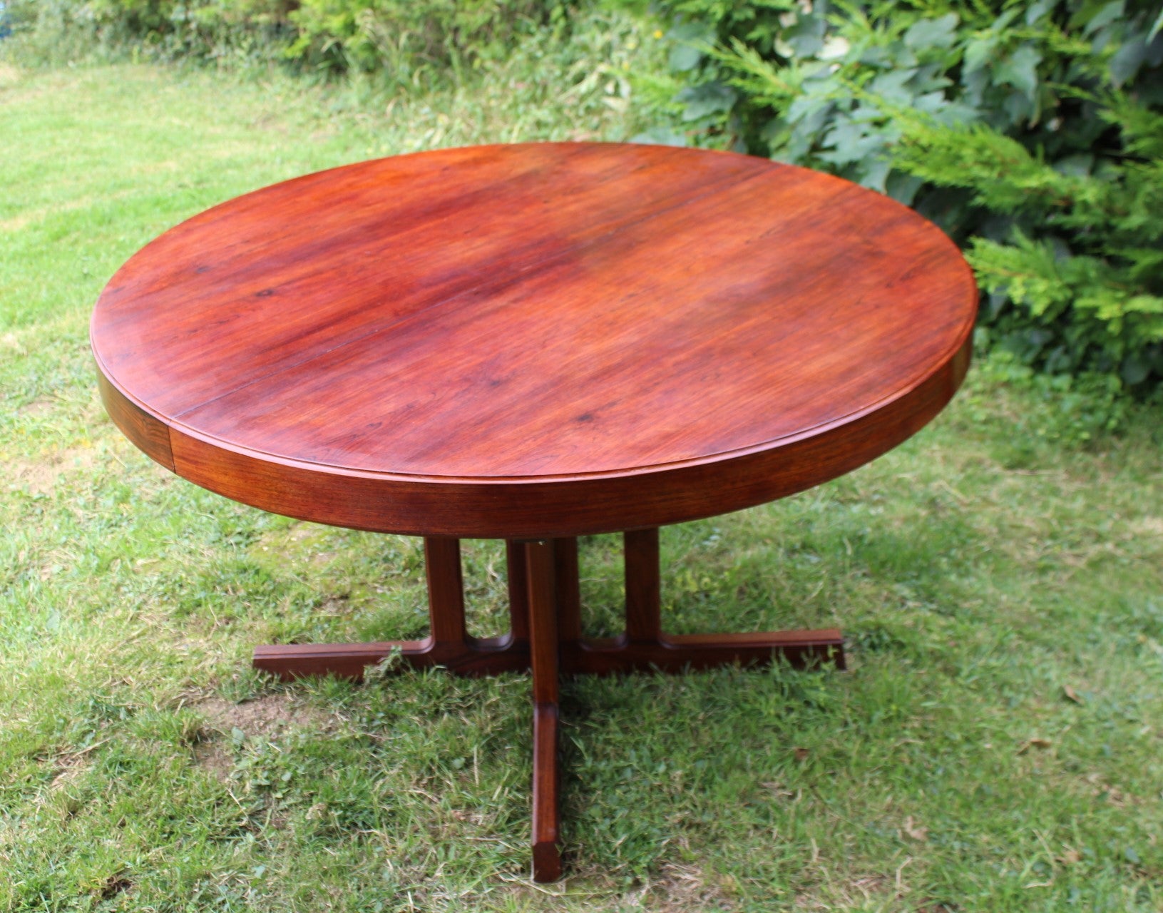 Large rosewood dining table by Johannes Andersen in a midcentury modern setting.