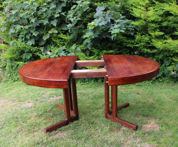 Luxury rosewood table with an extendable mechanism for versatile seating.