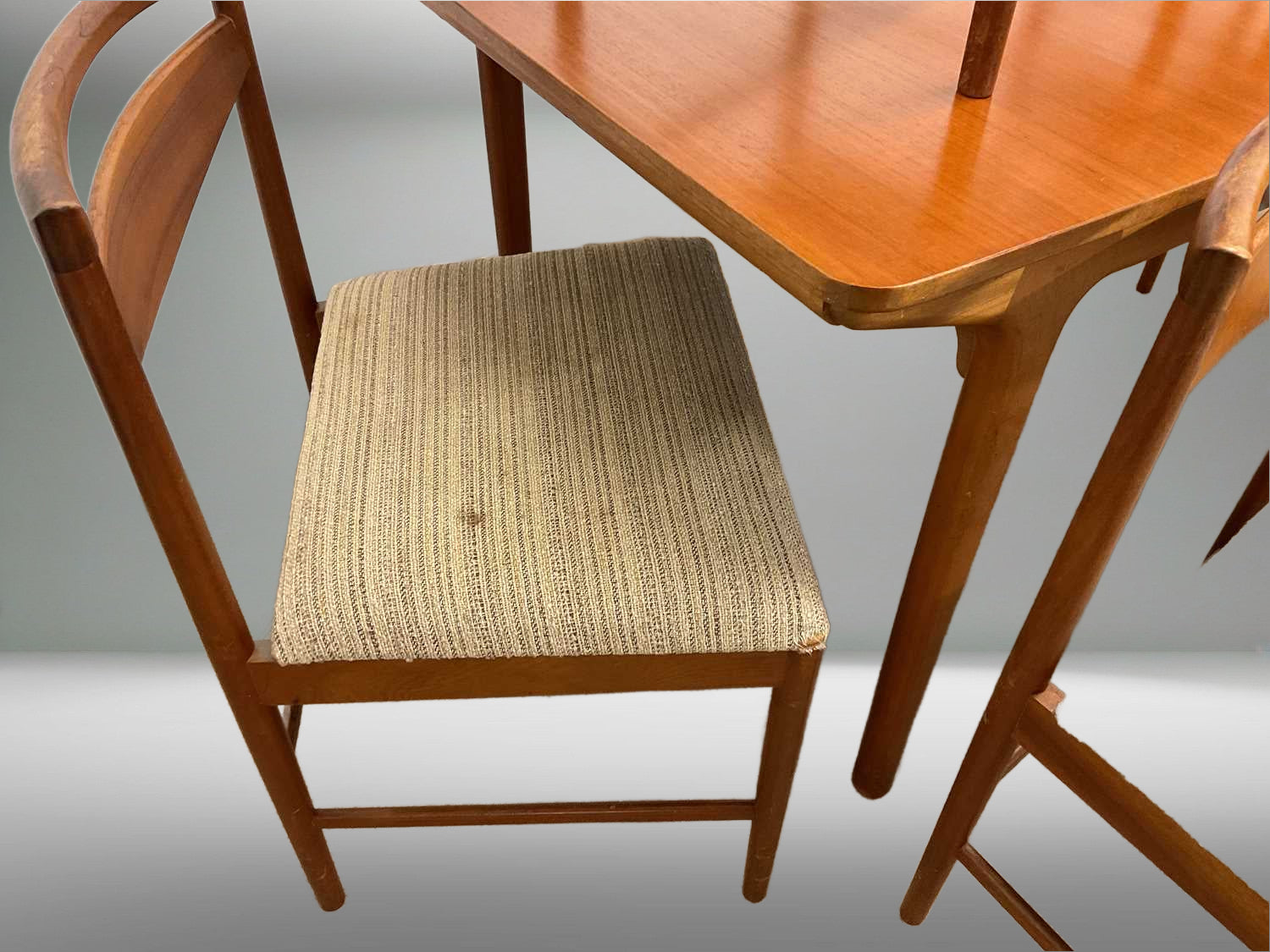 Mid-Century designer Tom Robertson designed the McIntosh teak dining chair featuring sleek lines, premium teak wood, and ergonomic back support