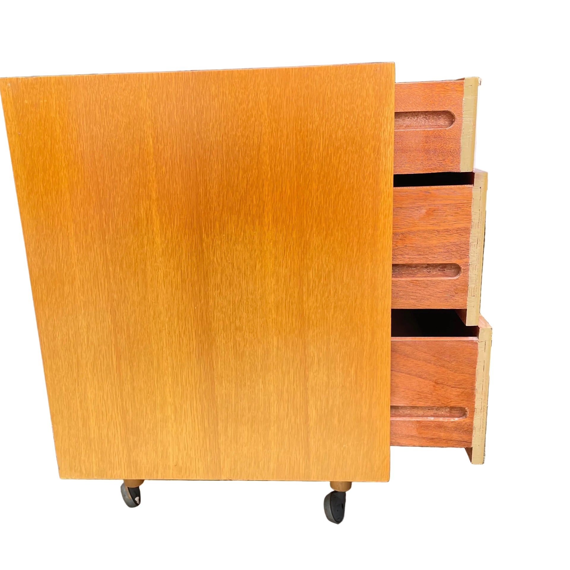 Wooden side view of oak chest of drawers on wheels outdoors by Stag 