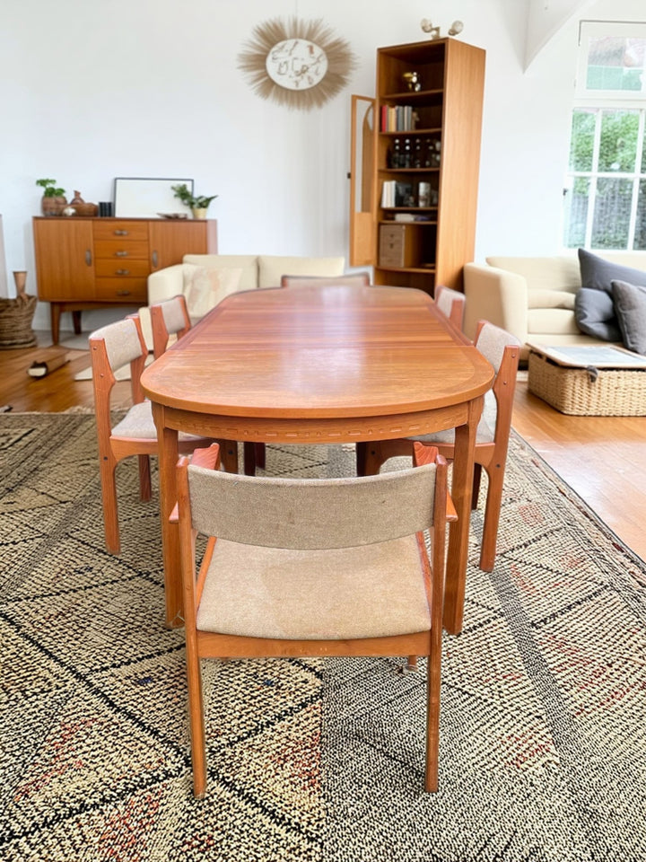 Dining room with wooden table and chairs on a patterned rug By Nil Jonsson for Troeds.