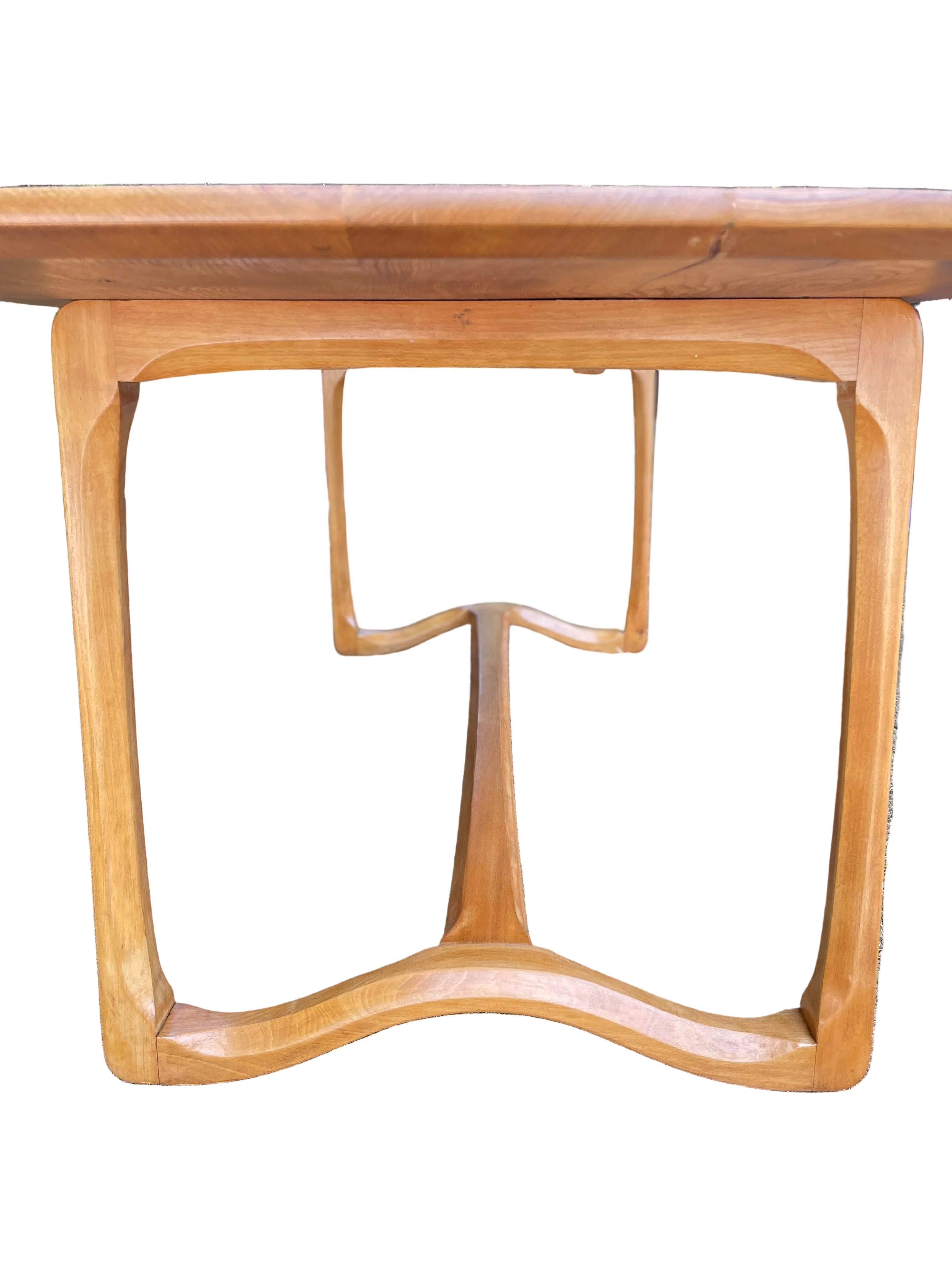 close-up of a wooden dining table base with a warm honey finish