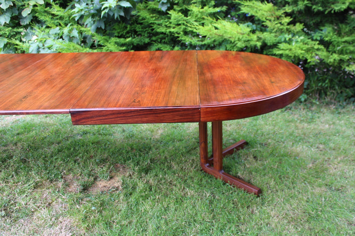 Scandinavian extendable dining table with a smooth rosewood finish