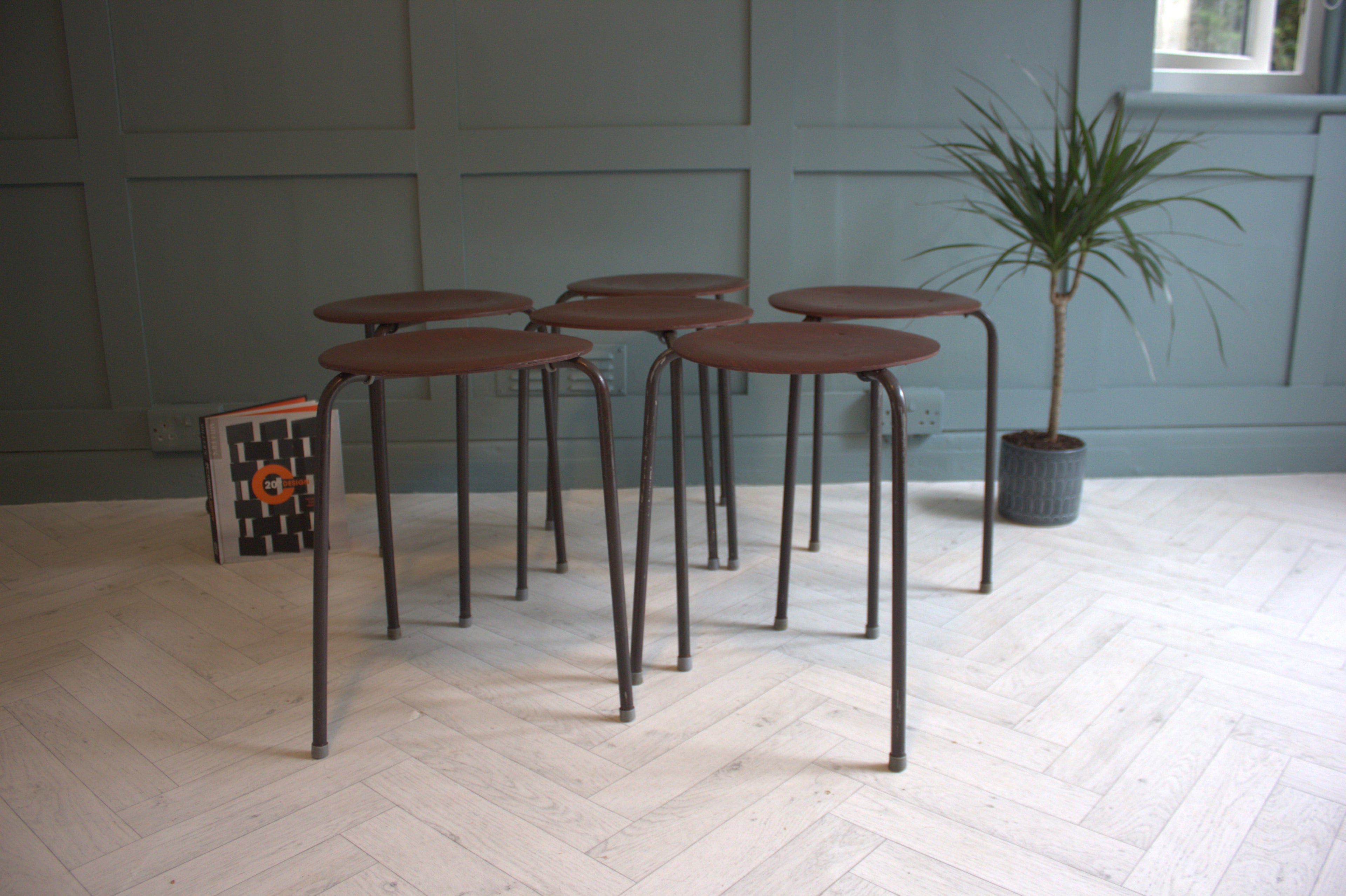Side view of mid-century modern stacking teak stools, designed by Arne Jacobsen