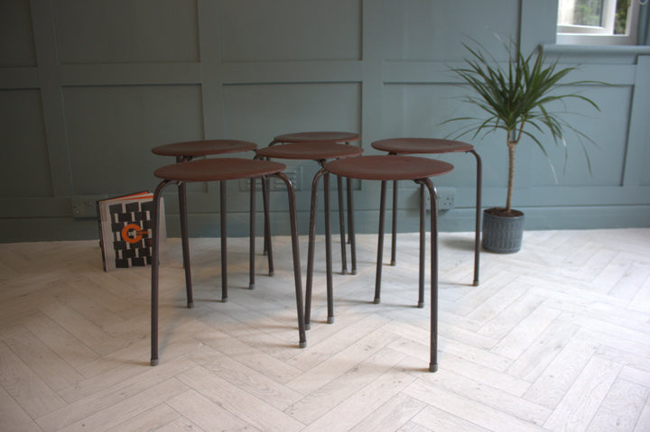 Side view of mid-century modern stacking teak stools, designed by Arne Jacobsen