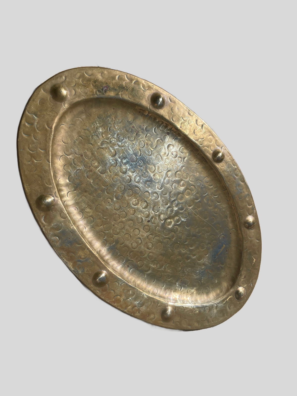 Side view showing the tray’s raised rim and oval form