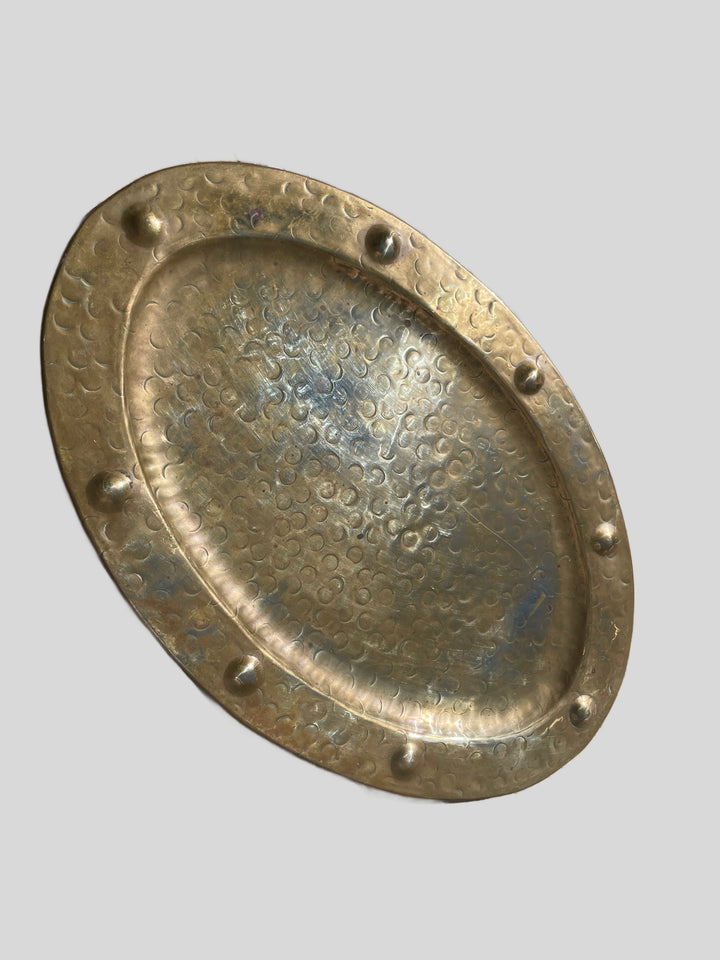 Side view showing the tray’s raised rim and oval form