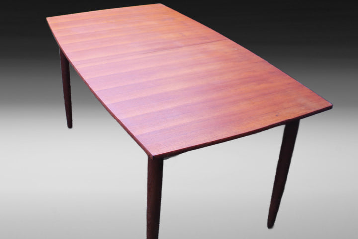 Solid teak extendable dining table with a hidden leaf mechanism