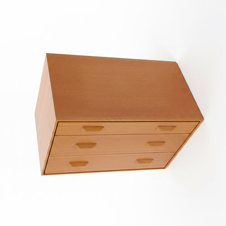 Wooden box with multiple drawers on a white background