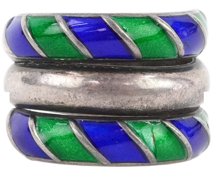 Silver ring with blue and green striped inlay on a white background