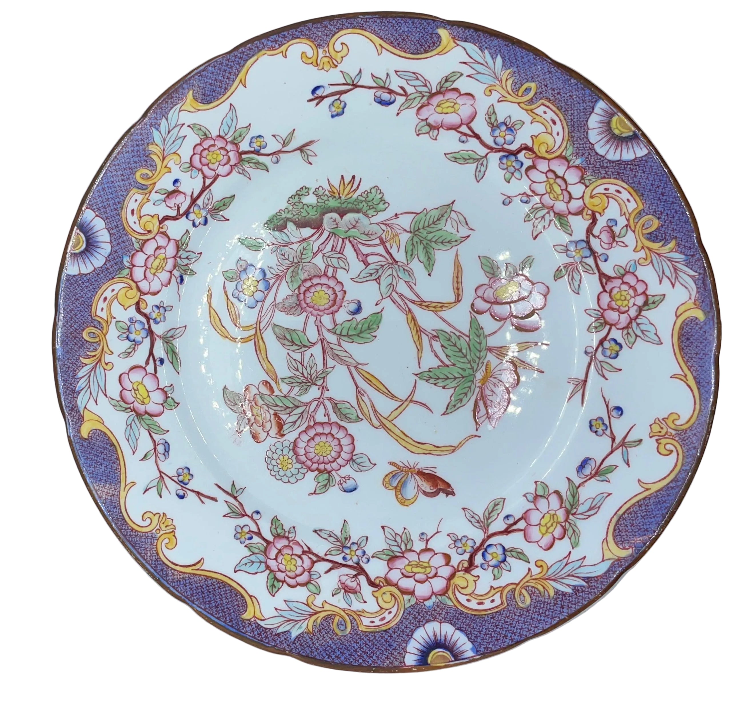 round white porcelain plate with an ornate floral pattern, featuring a purple border, yellow scrollwork, and pink flowers, shown inside a white box.