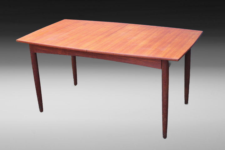 Vintage extendable teak dining table with smooth wood grain and a warm finish
