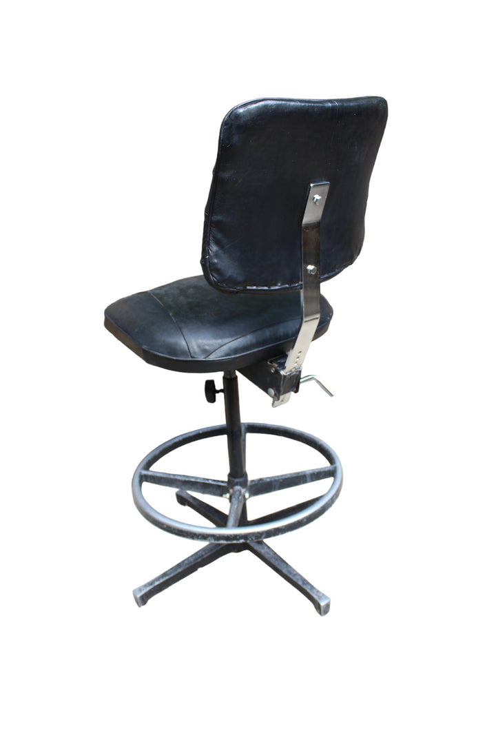 Vintage rotating chair with a durable steel base and footrest ring